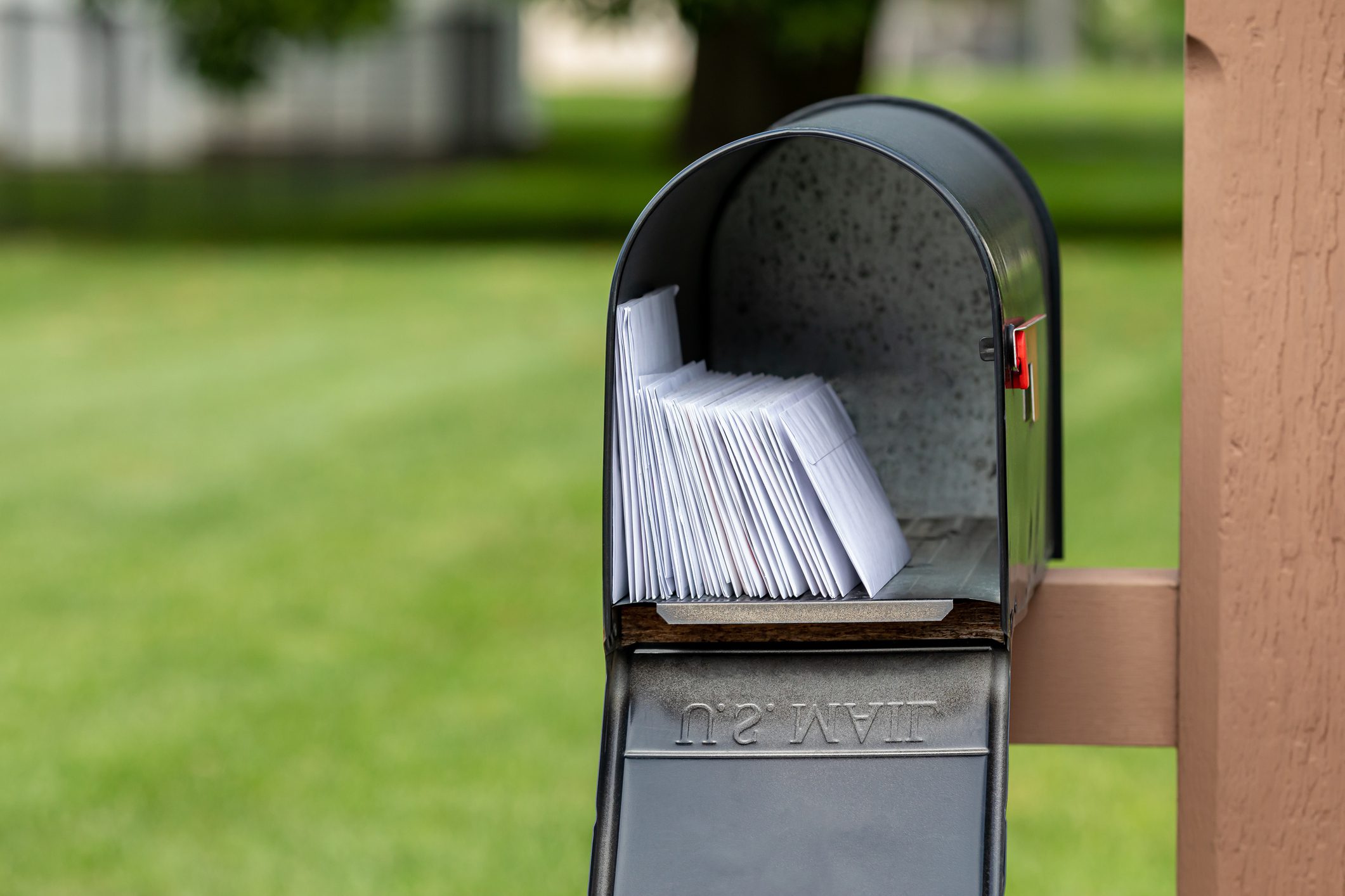 Mailbox full of mail outdoors