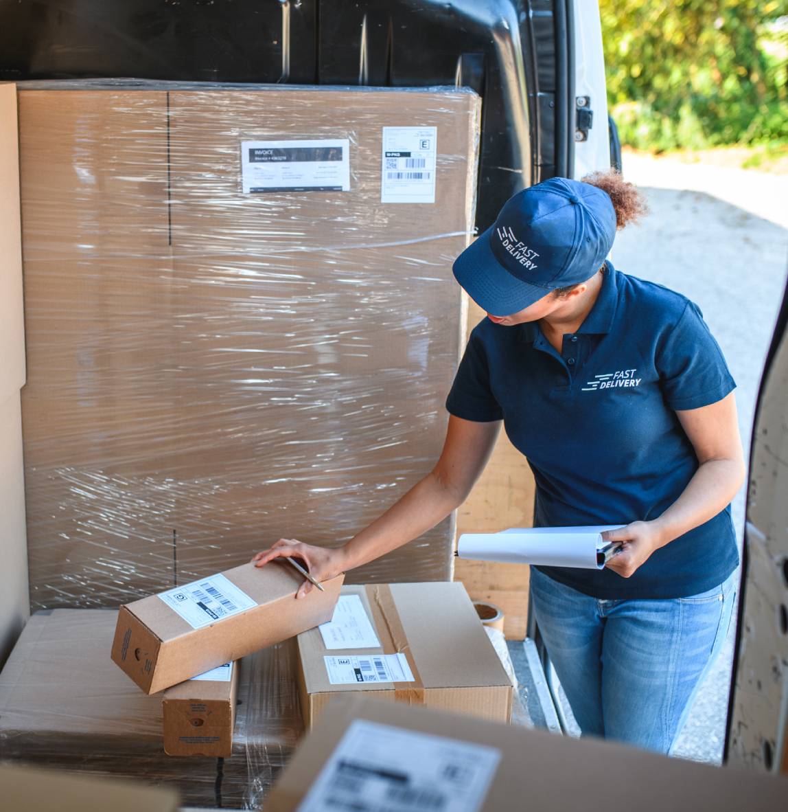 Delivery worker organizing packages in a van