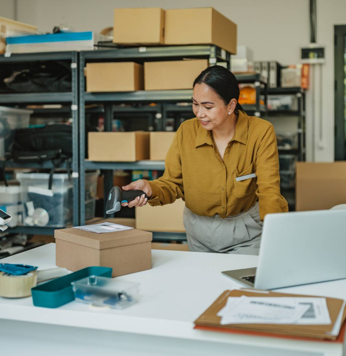 Woman scanning package in warehouse