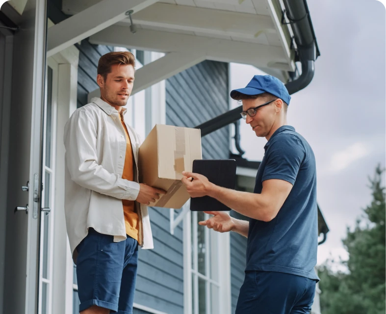 Delivery person handing package to man