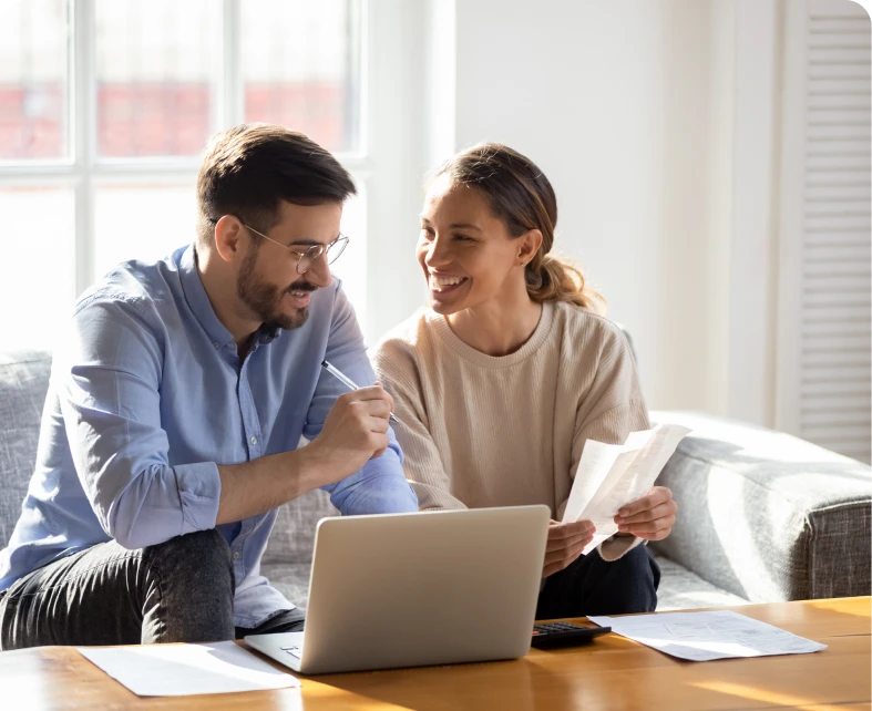 Couple discussing finances with laptop