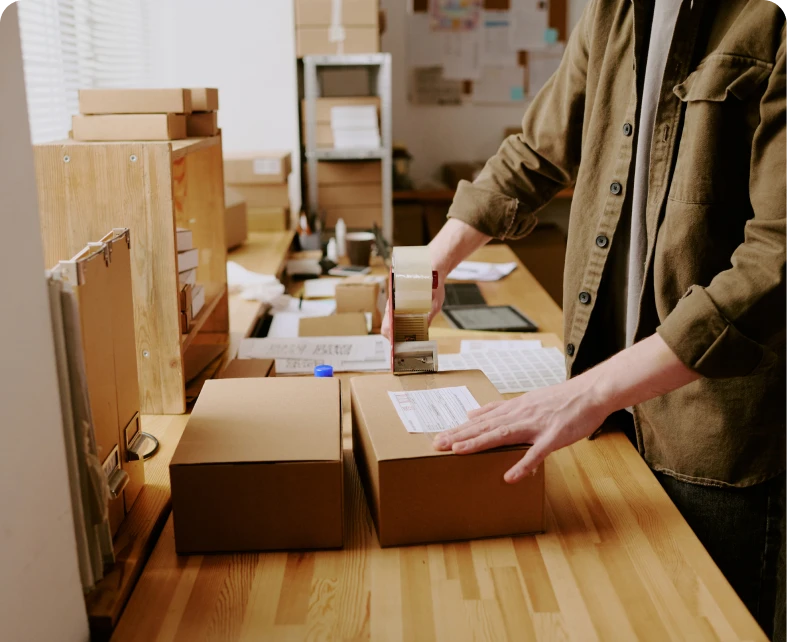 Office worker stamping cardboard boxes