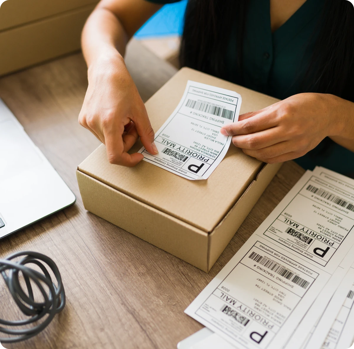 Applying shipping label to cardboard box