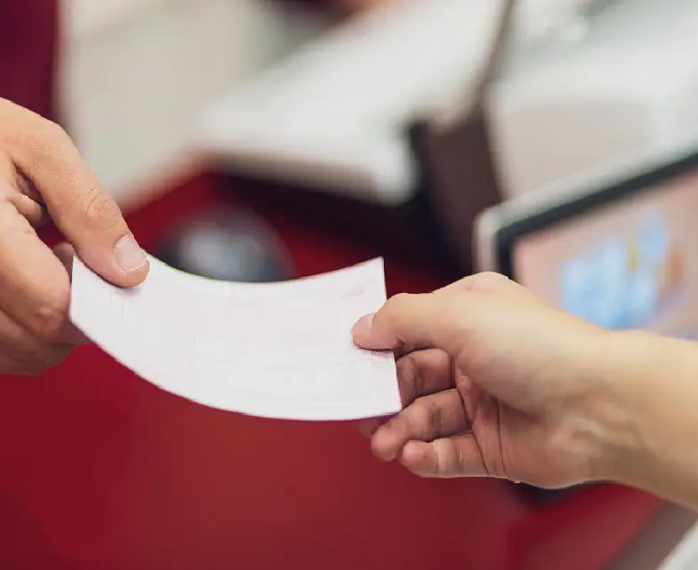 One person handing a blank business card to another.
