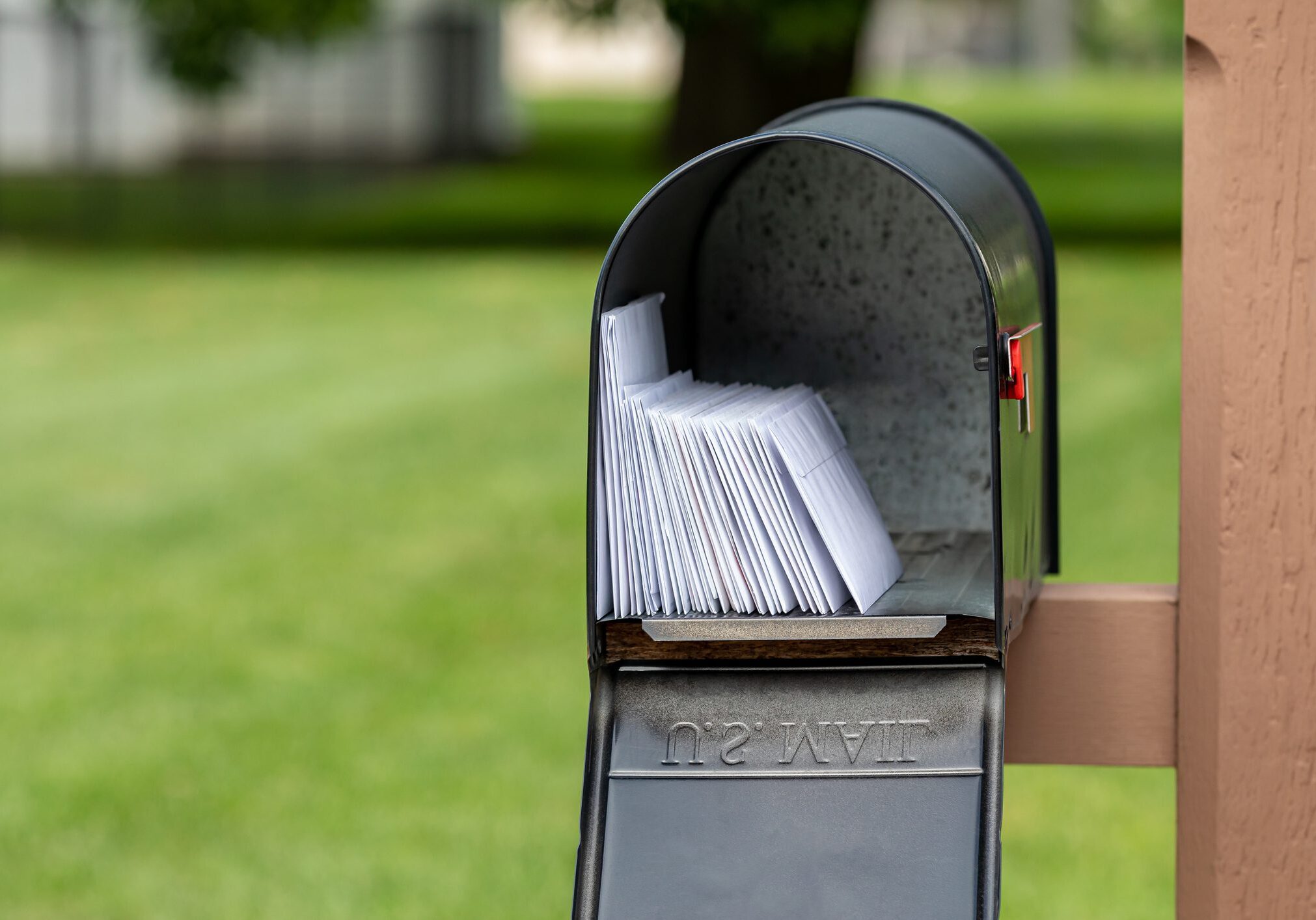 Mailbox full of mail outdoors